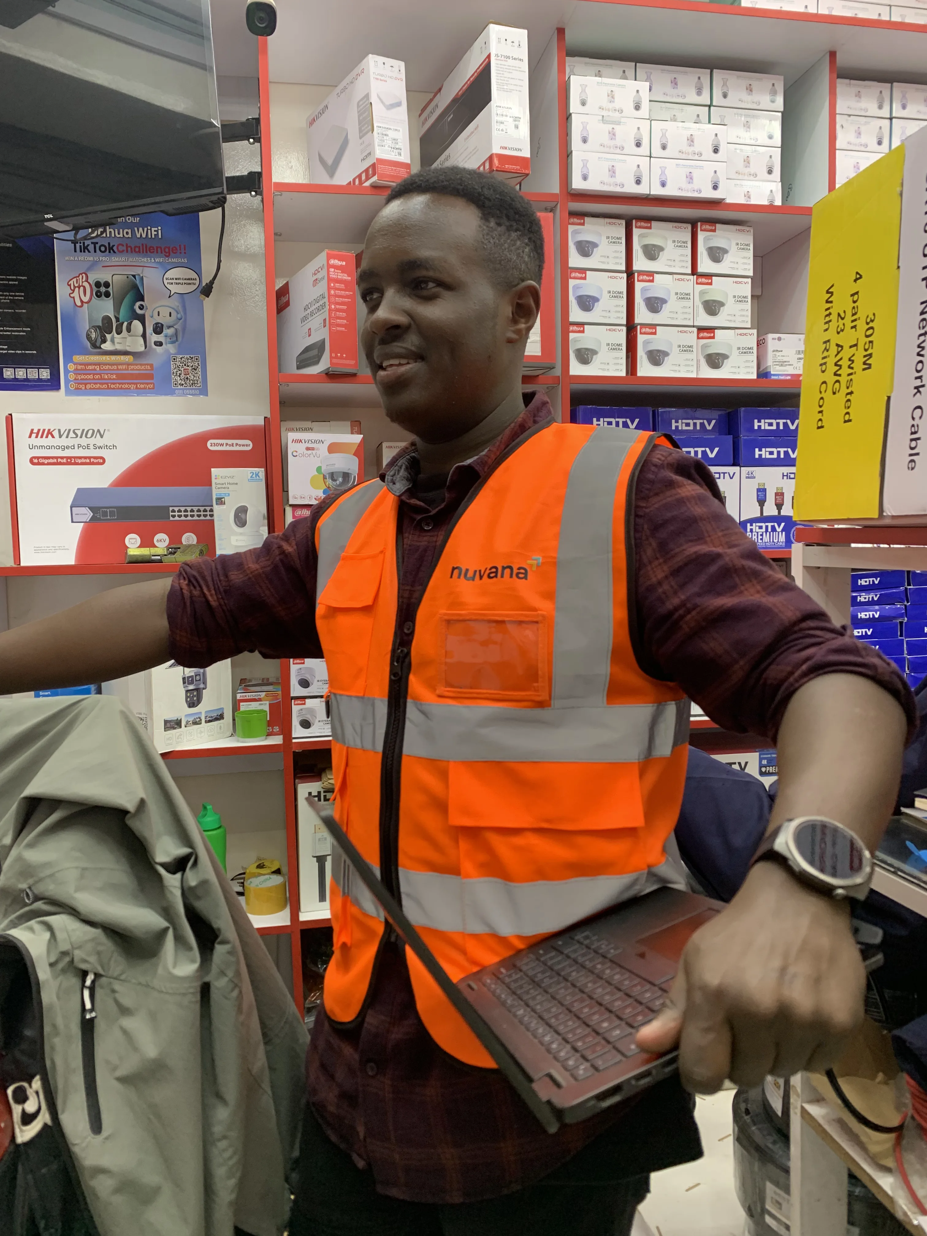 Wahome Maina doing retail systems work inside a Kenyan shop